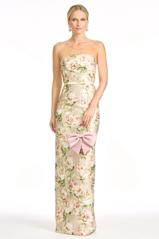 Sachin & Babi Sophia Gown - Pewter Camellia S263G39-287 Woman wearing a floral strapless gown with a pink bow on a white background