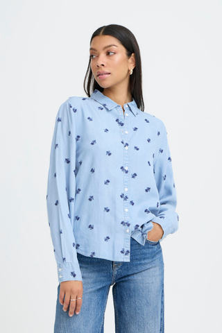 Woman wearing a light blue floral shirt and jeans on a white background b. young BYKosmo Boho Embroidered Shirt