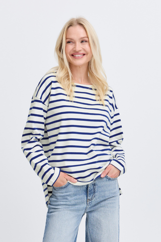 Woman wearing a blue and white striped sweater and jeans on a light gray background b young BYRamsi Pullover