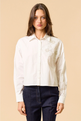 lalavon ILT6382 Off White Floral Appliqué Button Down Shirt Woman wearing a white blouse with a beige background
